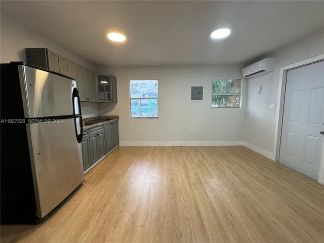 a kitchen with a stove refrigerator and microwave