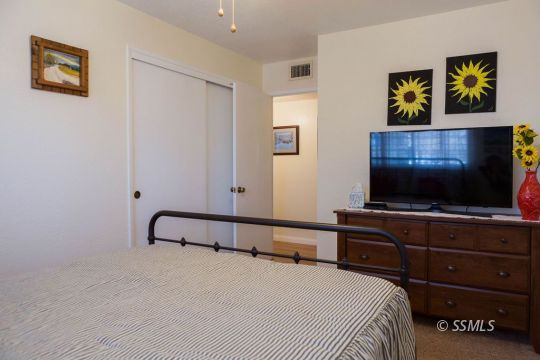 1108 South Allen Street Ridgecrest, CA 93555 - Photo 23 of 34 a bedroom with a bed and a flat screen tv