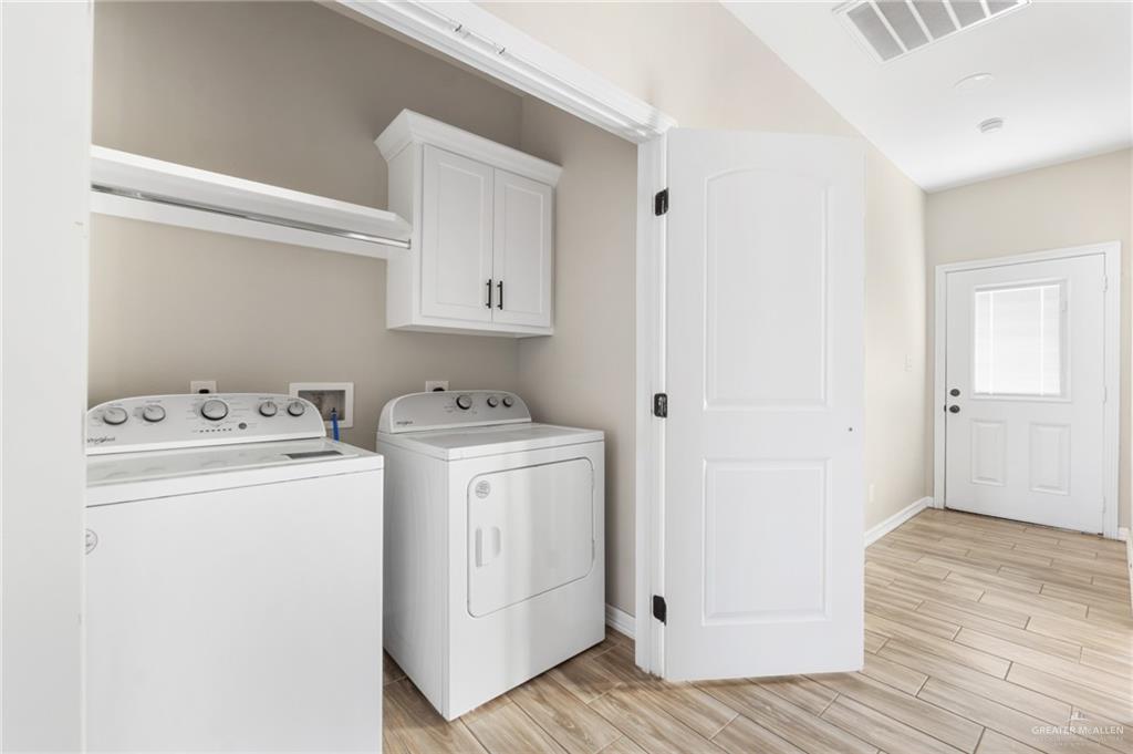 437 5th Street La Joya, TX 78560 - Photo 8 of 9 a view of a storage and utility room with washer and dryer