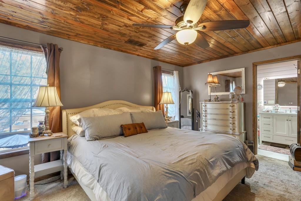 429 Red Oak Court Monroe, GA 30655 - Photo 16 of 40 a bedroom with a large bed and a chandelier