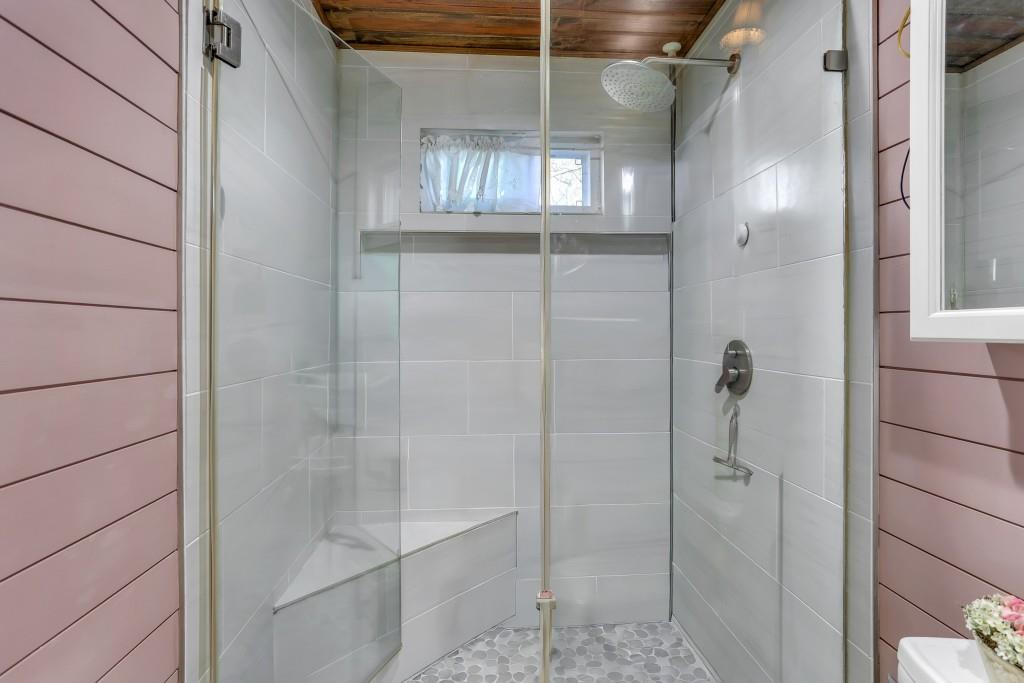 429 Red Oak Court Monroe, GA 30655 - Photo 19 of 40 a bathroom with a glass shower door and a window