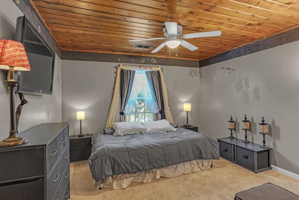 429 Red Oak Court Monroe, GA 30655 - Photo 21 of 40 a bedroom with a bed and a chandelier