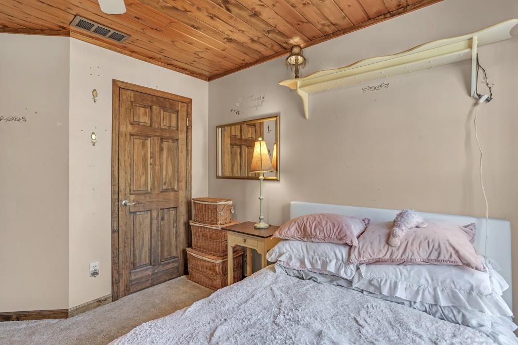 429 Red Oak Court Monroe, GA 30655 - Photo 26 of 40 a bedroom with a bed and a mirror