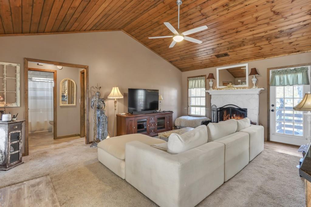 429 Red Oak Court Monroe, GA 30655 - Photo 7 of 40 a living room with furniture a fireplace and a flat screen tv