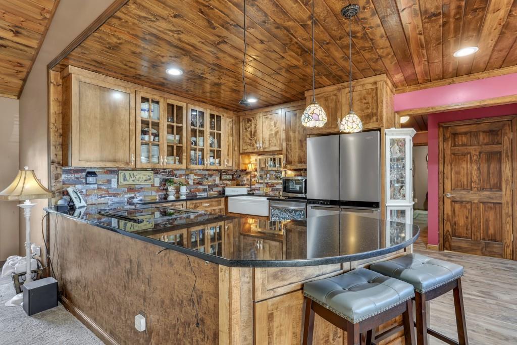 429 Red Oak Court Monroe, GA 30655 - Photo 9 of 40 a kitchen with refrigerator and chairs
