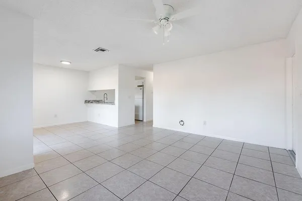 a view of an empty room and a window