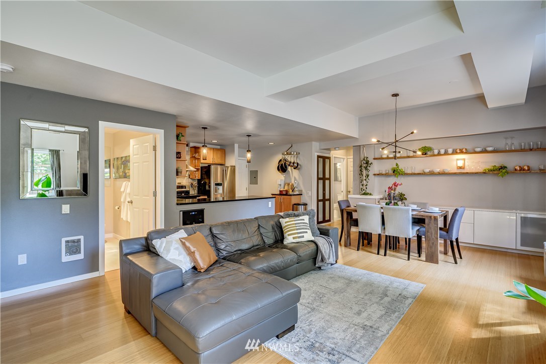 115 West Galer Street, Unit 101 Seattle, WA 98119 - Photo 2 of 23 a living room with furniture and a dining table