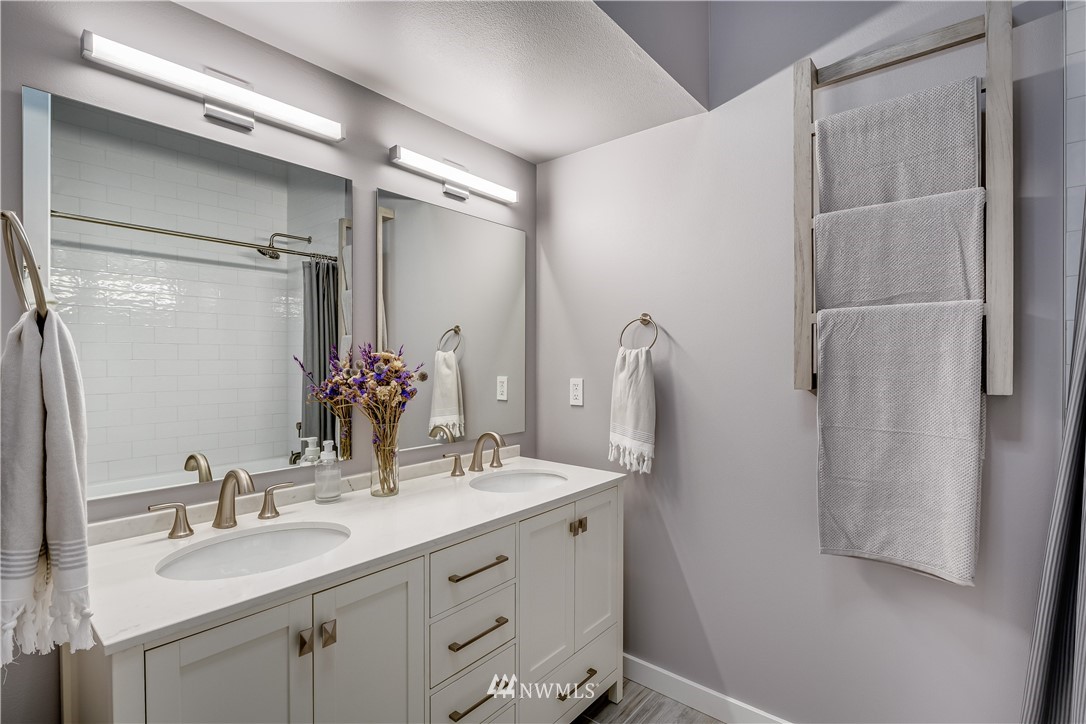 115 West Galer Street, Unit 101 Seattle, WA 98119 - Photo 11 of 23 a bathroom with a double vanity sink mirror and shower