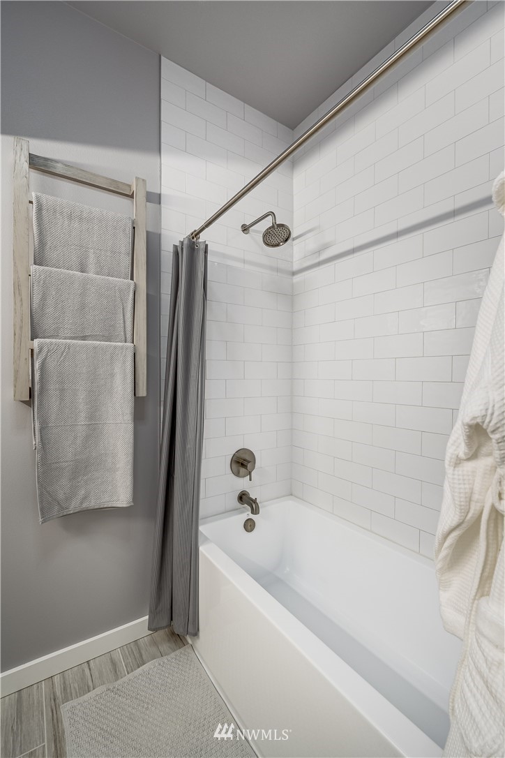 115 West Galer Street, Unit 101 Seattle, WA 98119 - Photo 12 of 23 a bathroom with a bathtub and a shower