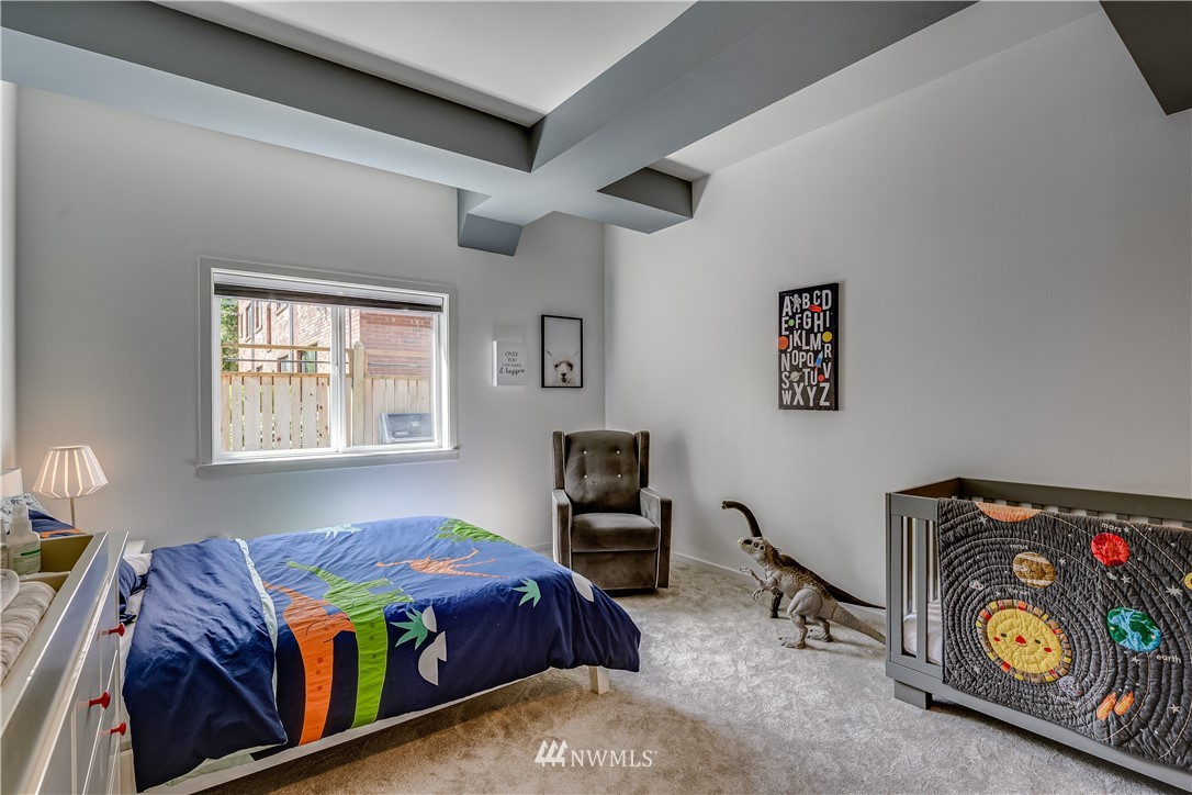 115 West Galer Street, Unit 101 Seattle, WA 98119 - Photo 13 of 23 a bedroom with a bed and a window