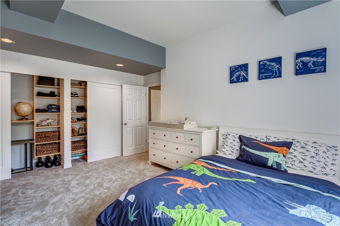 115 West Galer Street, Unit 101 Seattle, WA 98119 - Photo 14 of 23 a bedroom with a bed and furniture