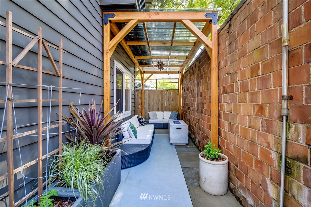 115 West Galer Street, Unit 101 Seattle, WA 98119 - Photo 17 of 23 a view of a patio with couches and potted plants