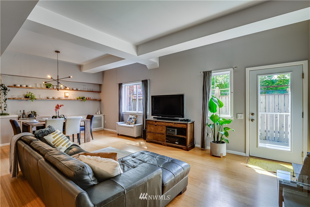 115 West Galer Street, Unit 101 Seattle, WA 98119 - Photo 3 of 23 a living room with furniture and a flat screen tv