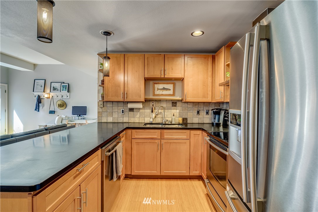 115 West Galer Street, Unit 101 Seattle, WA 98119 - Photo 6 of 23 a kitchen with stainless steel appliances granite countertop a stove a sink and a refrigerator