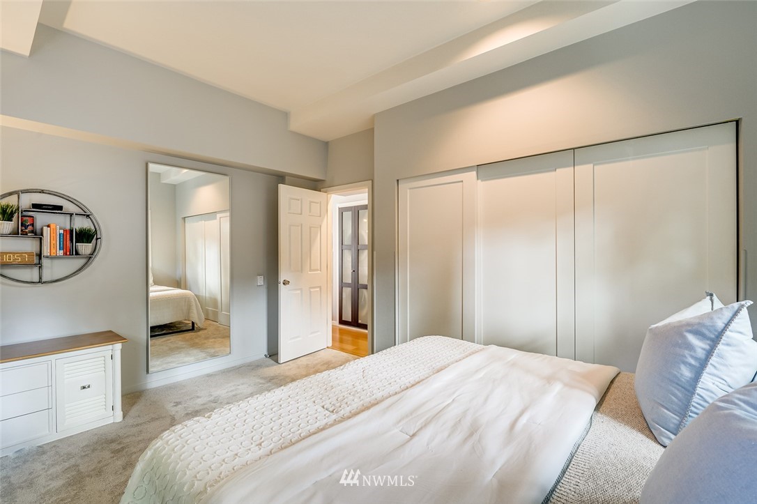 115 West Galer Street, Unit 101 Seattle, WA 98119 - Photo 8 of 23 a bedroom with a large bed and a couch