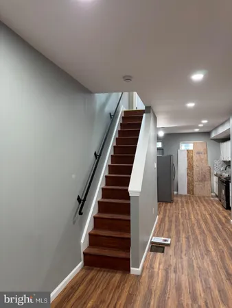 a view of entryway and hall with wooden floor