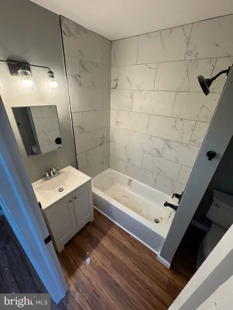 a bathroom with a bathtub and shower