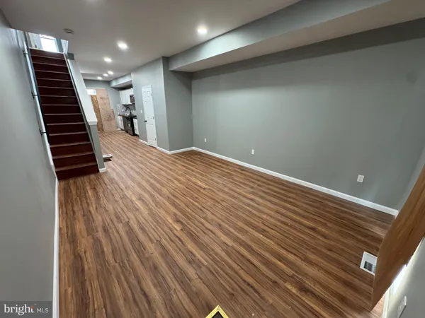 an empty room with wooden floor