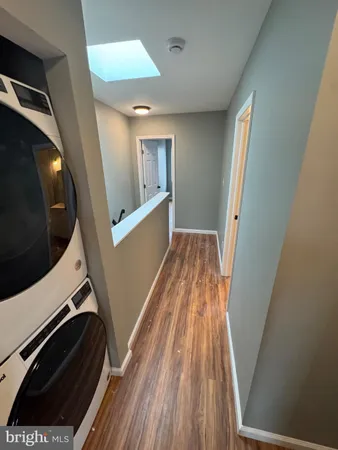 a view of a hallway with washer and dryer