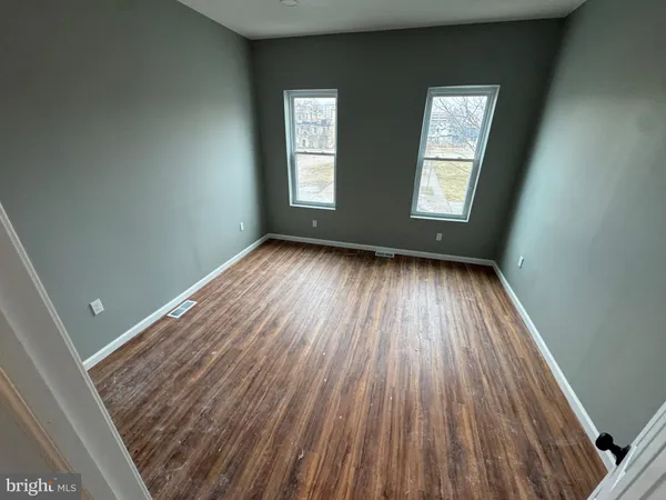 a view of a room with wooden floor and window