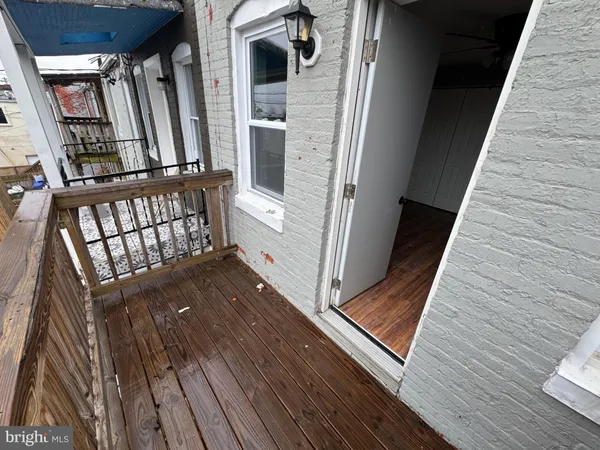 a view of a balcony with two chairs and a flat screen tv