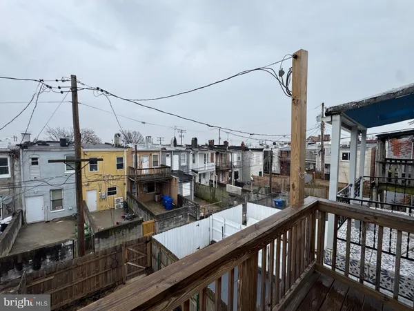 a view of a rooftop deck with couch and chairs