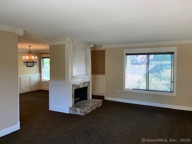 27 Canterbury Lane, Unit 27 Avon, CT 06001 - Photo 7 of 17 a view of an empty room with a fireplace and a window