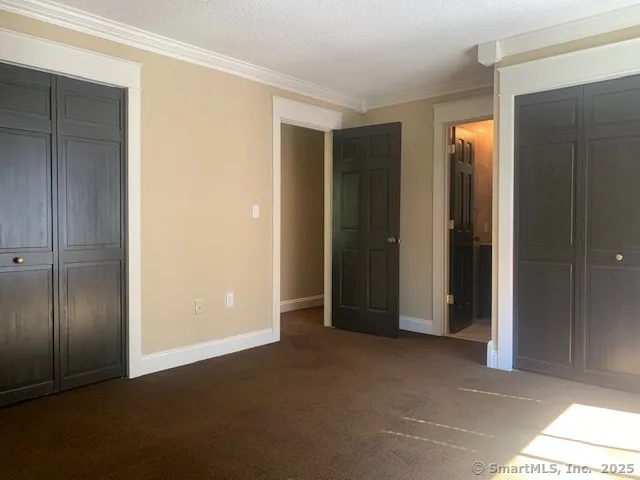 an empty room with closet and a bathroom