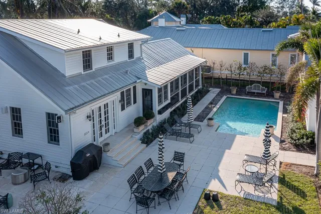a view of a patio with table and chairs potted plants with wooden floor and fence