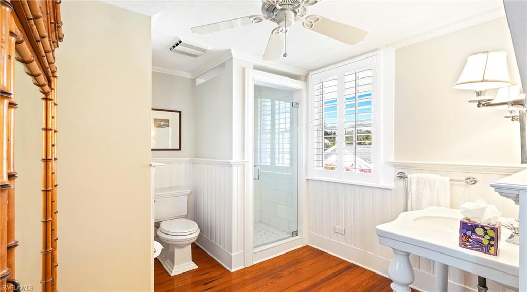 187 Broad Avenue South Naples, FL 34102 - Photo 12 of 33 a bathroom with a sink a toilet and shower curtain