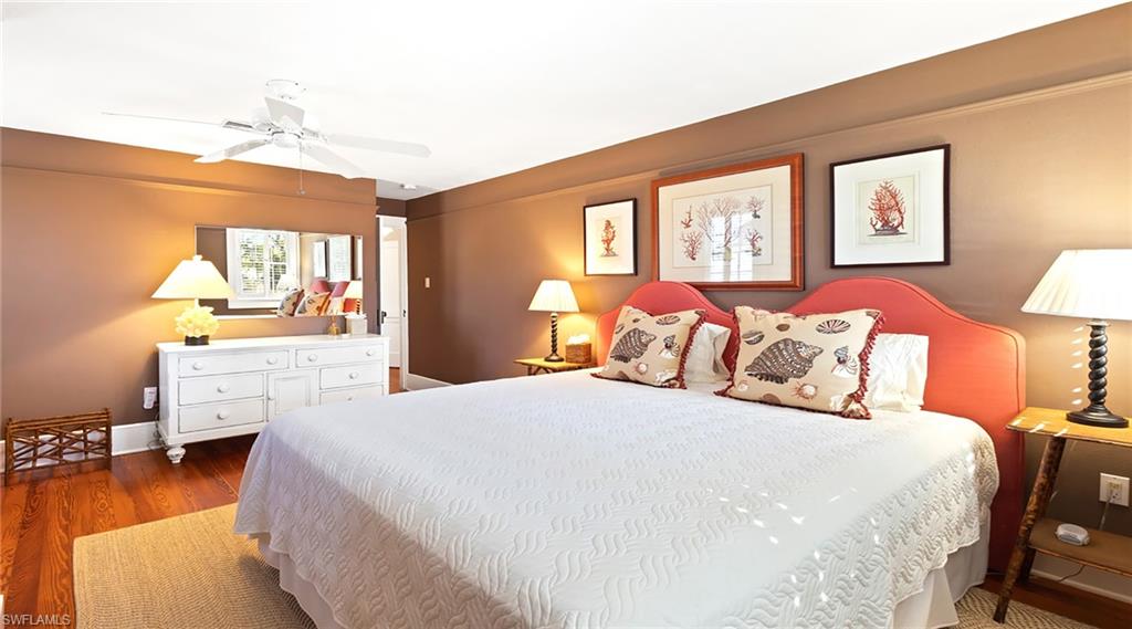 187 Broad Avenue South Naples, FL 34102 - Photo 13 of 33 a bedroom with a bed and wooden floor