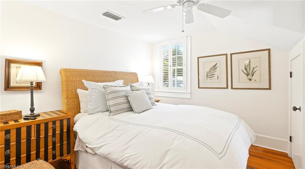 187 Broad Avenue South Naples, FL 34102 - Photo 15 of 33 a bedroom with a large bed and a window
