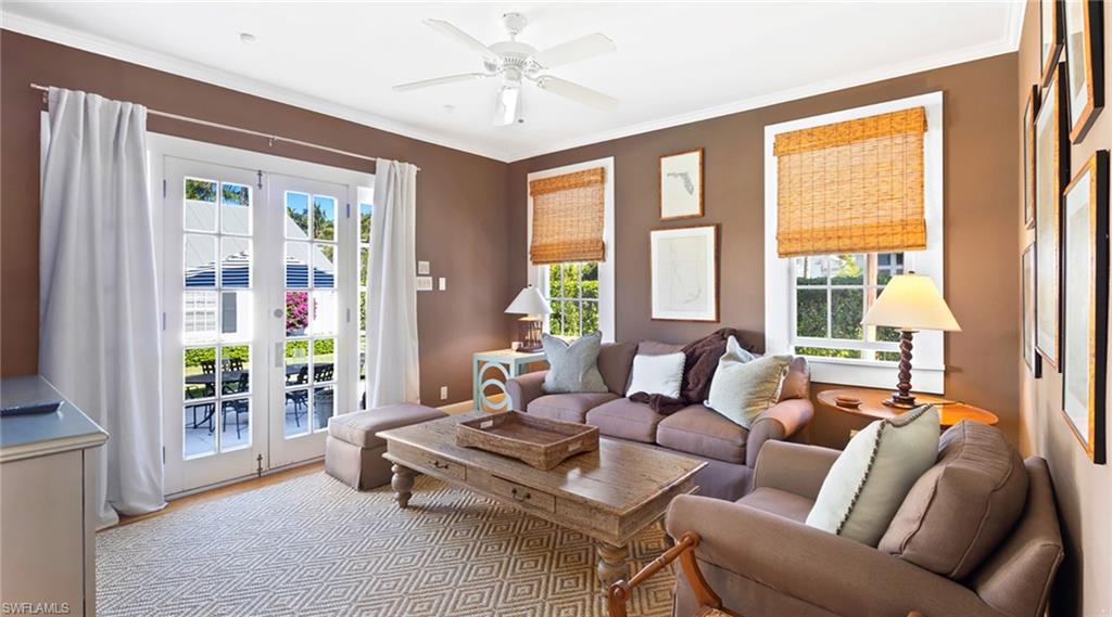 187 Broad Avenue South Naples, FL 34102 - Photo 17 of 33 a living room with furniture and a floor to ceiling window