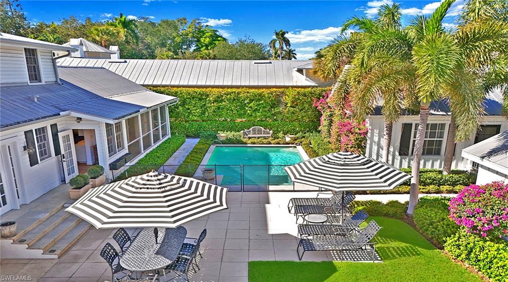 187 Broad Avenue South Naples, FL 34102 - Photo 20 of 33 a view of a patio with table and chairs and potted plants