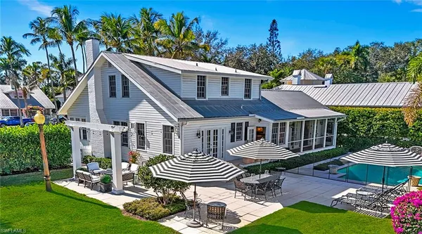 a front view of a house with garden and patio