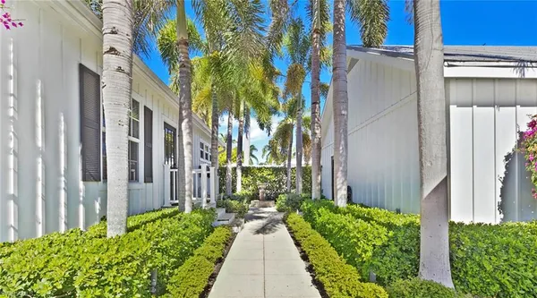 a front view of a house with outdoor seating and plants