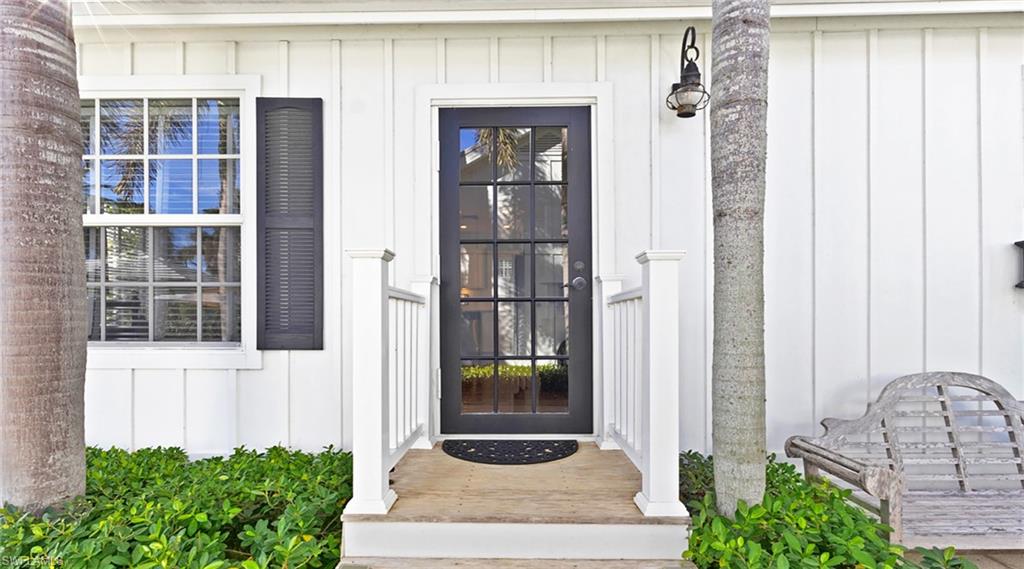 187 Broad Avenue South Naples, FL 34102 - Photo 22 of 33 a front view of a house with a yard