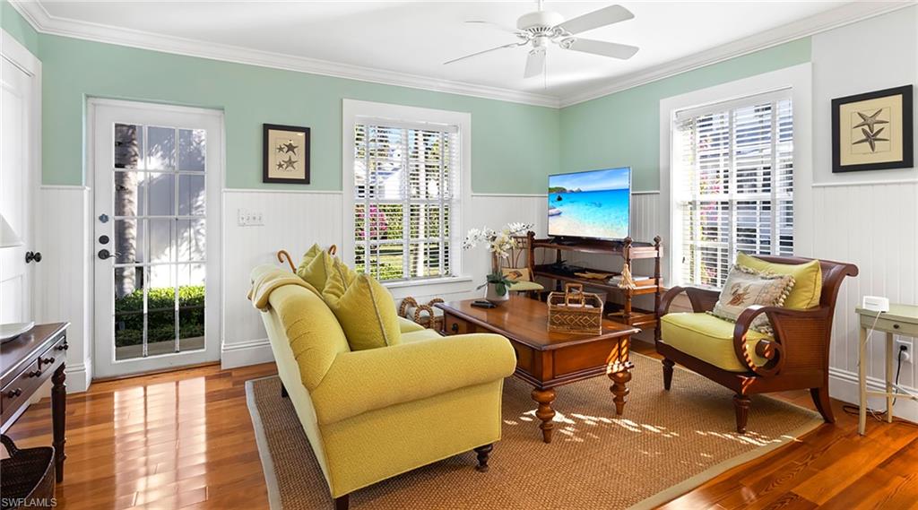 187 Broad Avenue South Naples, FL 34102 - Photo 23 of 33 Sitting room with ornamental molding, wood finished floors, a ceiling fan, and wainscoting