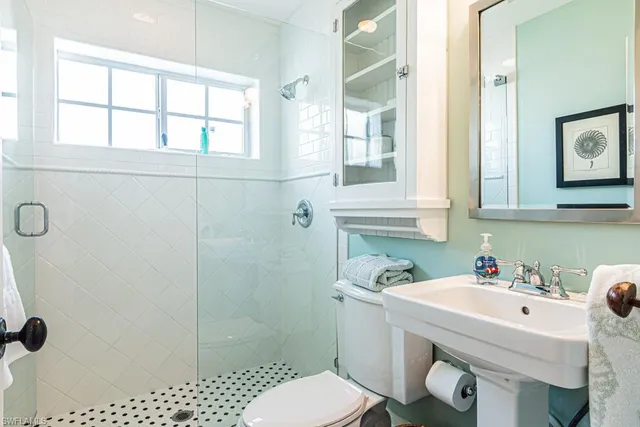 a bathroom with a sink toilet and shower