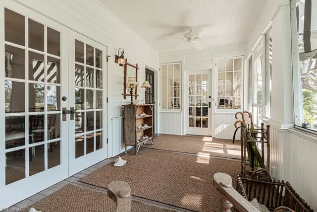 a view of living room filled with furniture and large windows