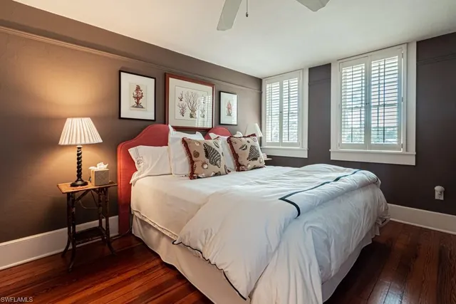 a bedroom with a bed a lamp on table and a window