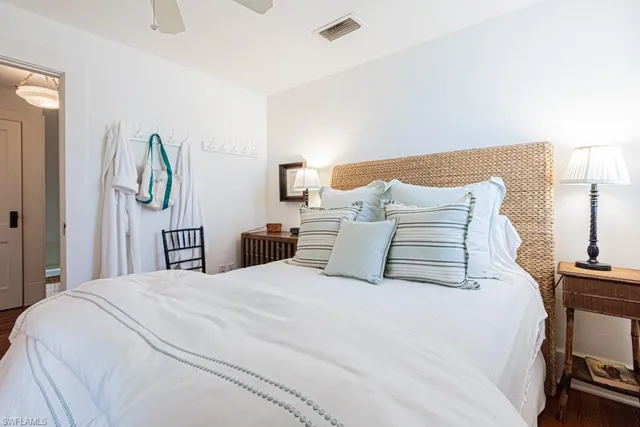 a bedroom with a bed and a lamp