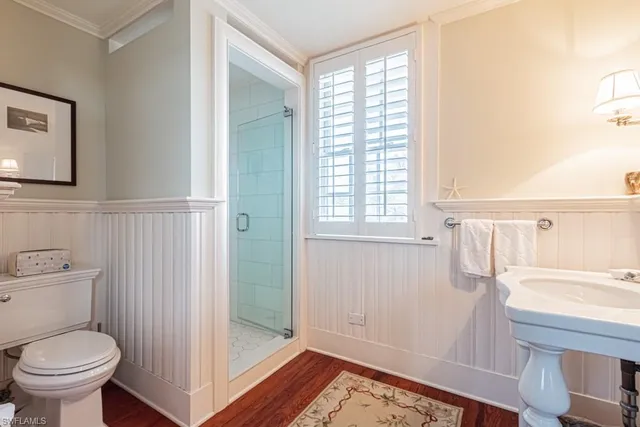 a bathroom with a sink a toilet and shower