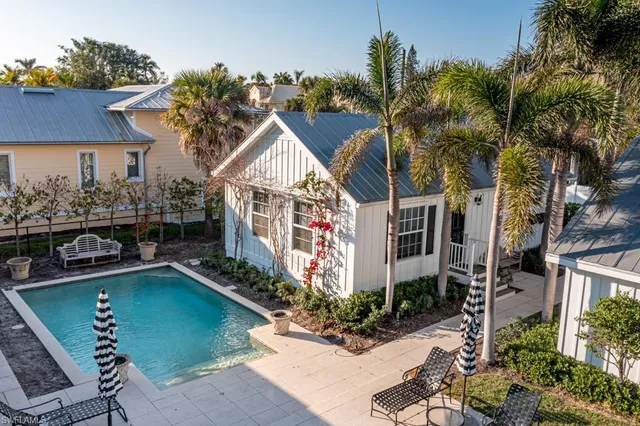 a view of a house with a swimming pool and a chairs