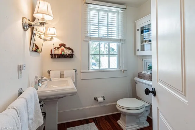 a bathroom with a sink toilet and mirror