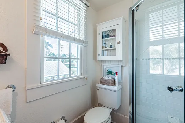 a bathroom with a toilet a sink and a window