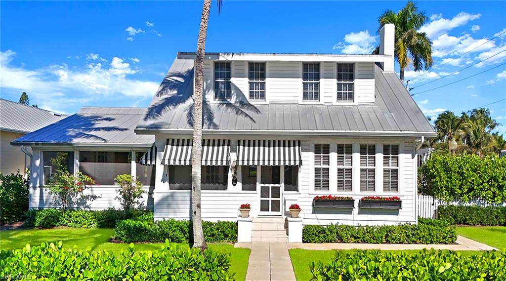 187 Broad Avenue South Naples, FL 34102 - Photo 4 of 33 front view of a house with a yard