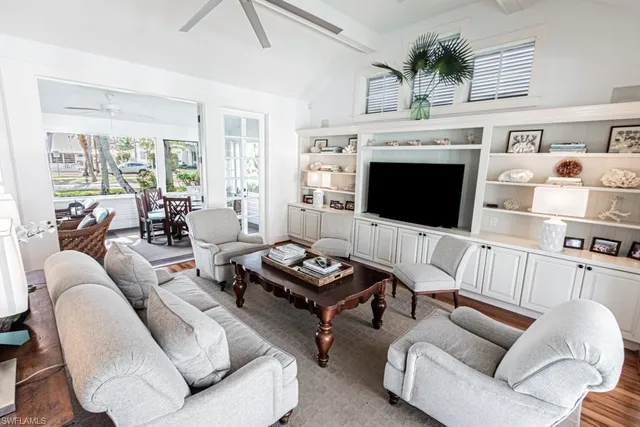 a living room with furniture fireplace and flat screen tv
