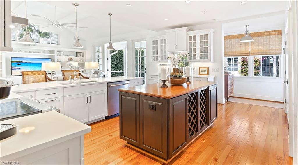 187 Broad Avenue South Naples, FL 34102 - Photo 6 of 33 a kitchen with stainless steel appliances granite countertop a stove a sink and a refrigerator