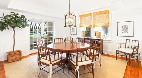 a bedroom with a bed a chandelier and a window